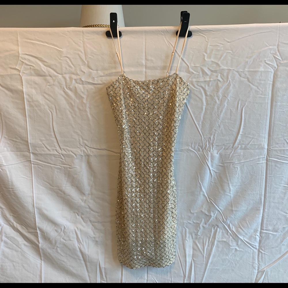 Janelle James- White with silver sequins dress